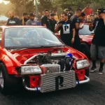 Drag racer staged at the starting line with the Christmas tree visible in natural daylight